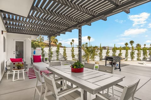Covered patio w/ dining table & lounge chairs, ideal for long meals in the desert breeze