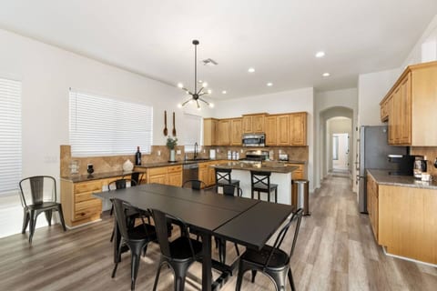 Open dining area w/ seating for eight, pendant lighting & the kitchen just steps away.
