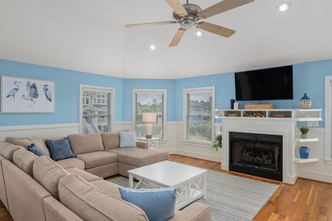 Bright, airy living room w/ plush seating, fireplace & flatscreen — ideal for cozy movie nights.