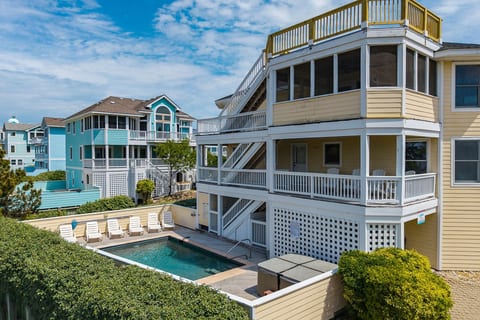 Stunning multi-story coastal home w/ wrap-around decks & a pool, perfect for a big group getaway.