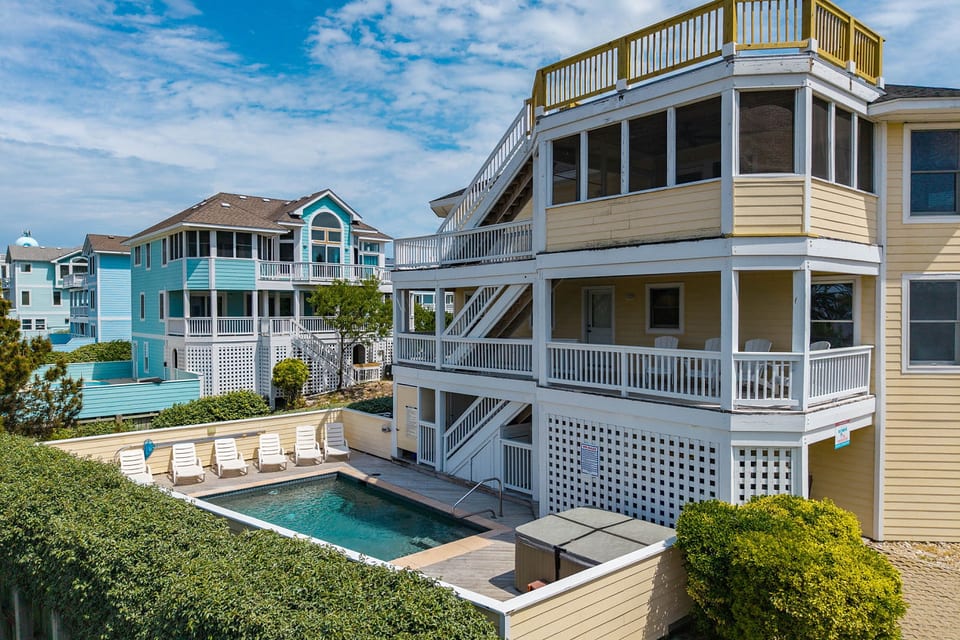 Stunning multi-story coastal home w/ wrap-around decks & a pool, perfect for a big group getaway.
