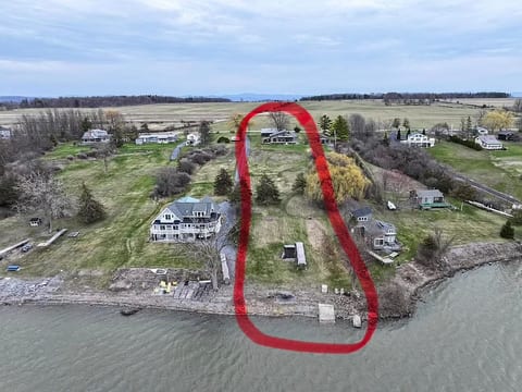 The house is at the top of the photo.  The backyard is 1.5 acres with a path leading to the lake, dock, and fire pit