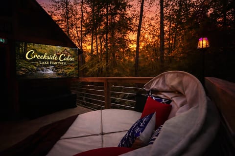 Tucked into the trees, the outdoor daybed creates an intimate retreat—plush cushions, soft evening light, and forest views set the stage for quiet conversations, shared sunsets, and relaxed moments together.