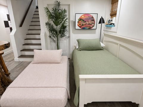Fun-filled game room with a twin daybed & trundle, 32” Smart TV, and retro console loaded with 20,000+ games. Enjoy board games, giant checkers, chess, and a take-one-leave-one library—perfect for family entertainment and cozy hangouts.