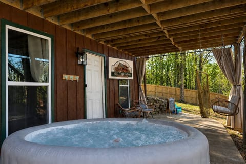 Private covered hot tub patio with woodland views and cozy seating