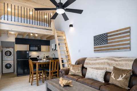 Warm wood tones, vaulted ceilings, and mountain-modern design set the mood inside this cozy Smoky Mountain cabin. Thoughtful details, soft lighting, and serene forest views create a romantic space made for slow mornings and peaceful nights.