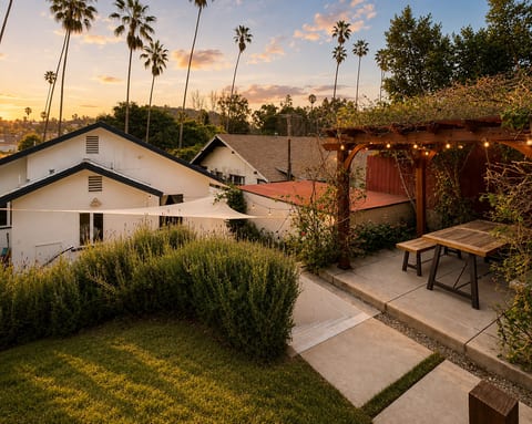 Sunset patio with string lights, palm views, and cozy outdoor dining