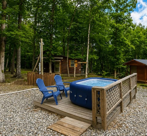 Private hot tub deck surrounded by trees for a peaceful cabin escape