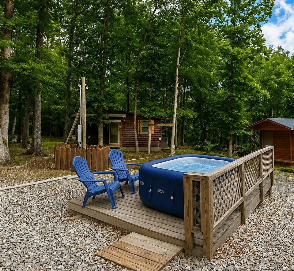 Private hot tub deck surrounded by trees for a peaceful cabin escape