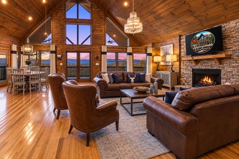 Vaulted great room with fireplace, mountain views, and warm lodge-style charm