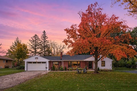 Charming ranch home with vibrant fall views and glowing sunset curb appeal