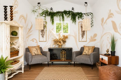 Cozy boho lounge with greenery, armchairs, and warm natural accents