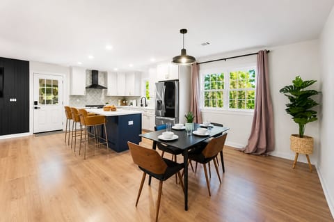 Bright open kitchen and dining area with island seating and natural light