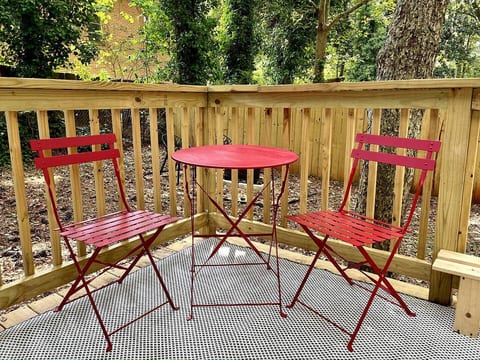"Enjoy the outdoors in this charming tiny home with a fully-fenced yard, a deck featuring a bistro set for two, and a cozy fire pit for two. Perfect for relaxing and making memories in your private outdoor retreat!"