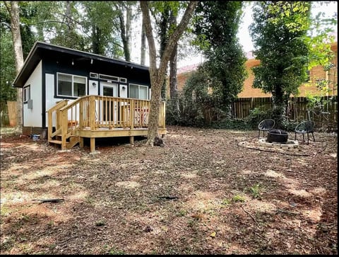 Outdoors, a fully-fenced yard, deck with a bistro set, and a fire pit await. Pet-friendly for your furry friends!