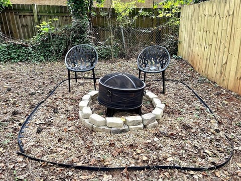 "Relax in the outdoors of this tiny home with a fully-fenced yard, a deck with a bistro set for two, and a fire pit for two. Ideal for enjoying quiet moments and cozy evenings under the stars!"