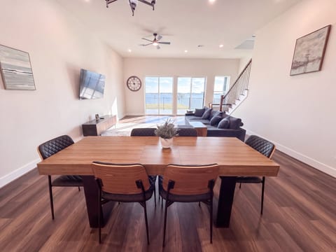 Bright open living space with waterfront views and stylish modern dining