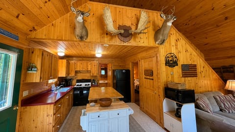 Rustic, fully equipped kitchen with warm wood interiors and plenty of space for preparing meals.