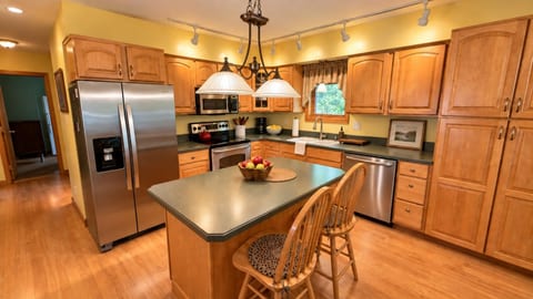 A bright, fully equipped kitchen with plenty of space for cooking and gathering.