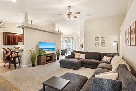 Vaulted ceilings, endless sectional, kitchen just steps away. This room proves you don't have to choose between space and staying close