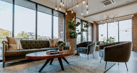 Bright designer lounge with floor-to-ceiling windows and chic seating