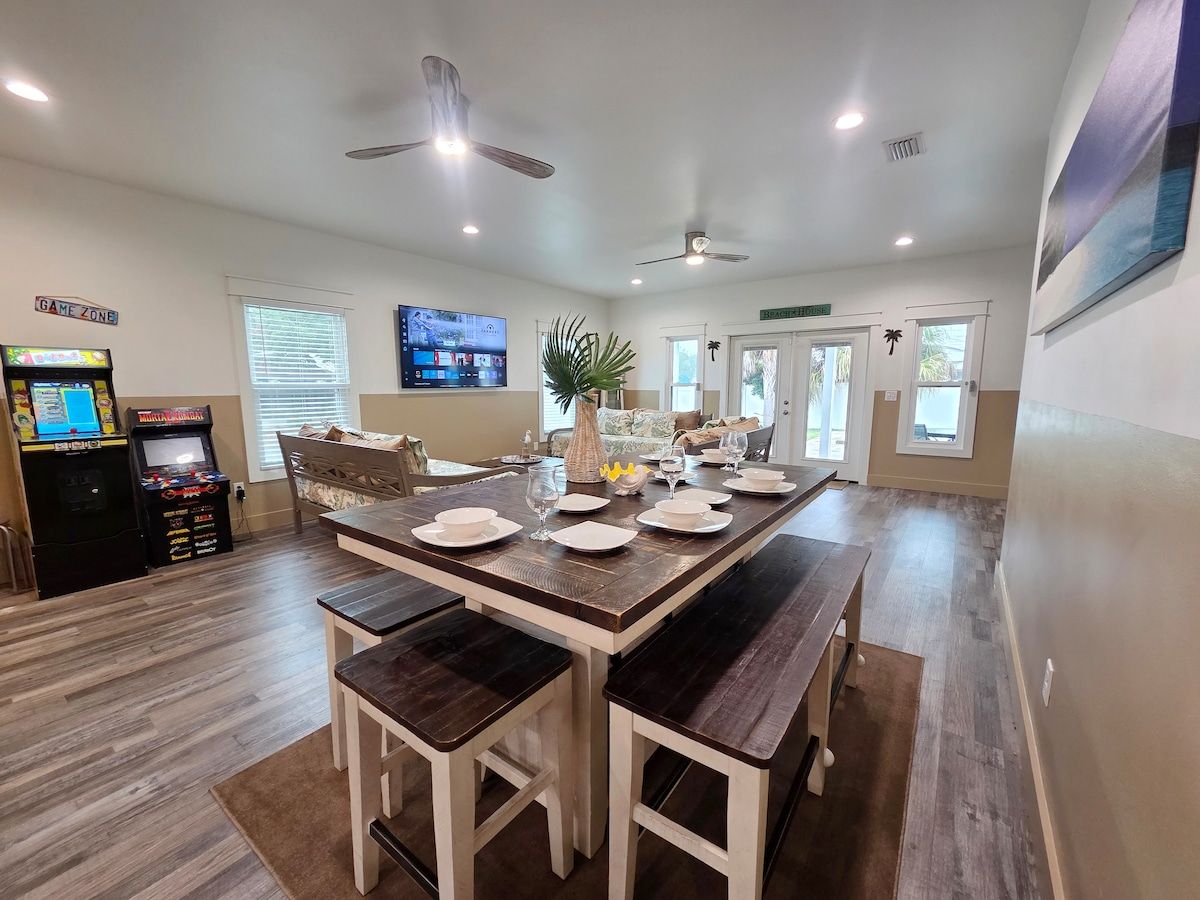 Living Room has 2 gaming systems w/ 3 twin size Day Beds, coffee table, with 70" Samsung Smart TV, and large dining table.