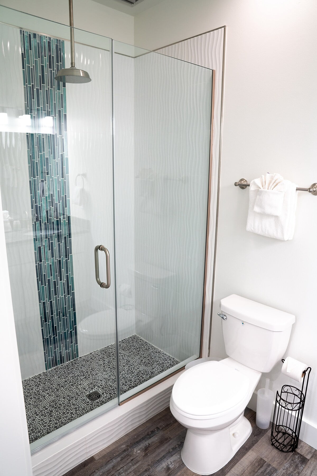 Master Bath with walk in shower and water fall shower head, double vanities, toilet, and ample cabinet space for storage.
