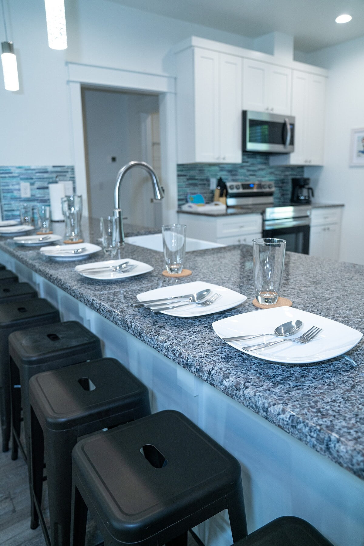 Kitchen w/ all new Stainless Steel appliances including a dishwasher, microwave, coffee maker, blender, and toaster. Room at the bar to sit and enjoy a snack or eat any meal.