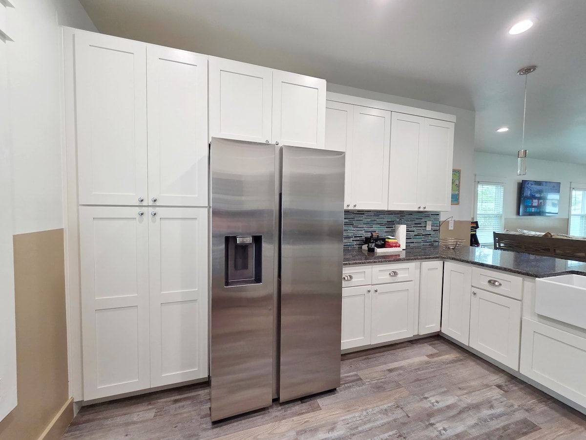 Kitchen w/ all new Stainless Steel appliances including a dishwasher, microwave, coffee maker, blender, and toaster. Room at the bar to sit and enjoy a snack or eat any meal.