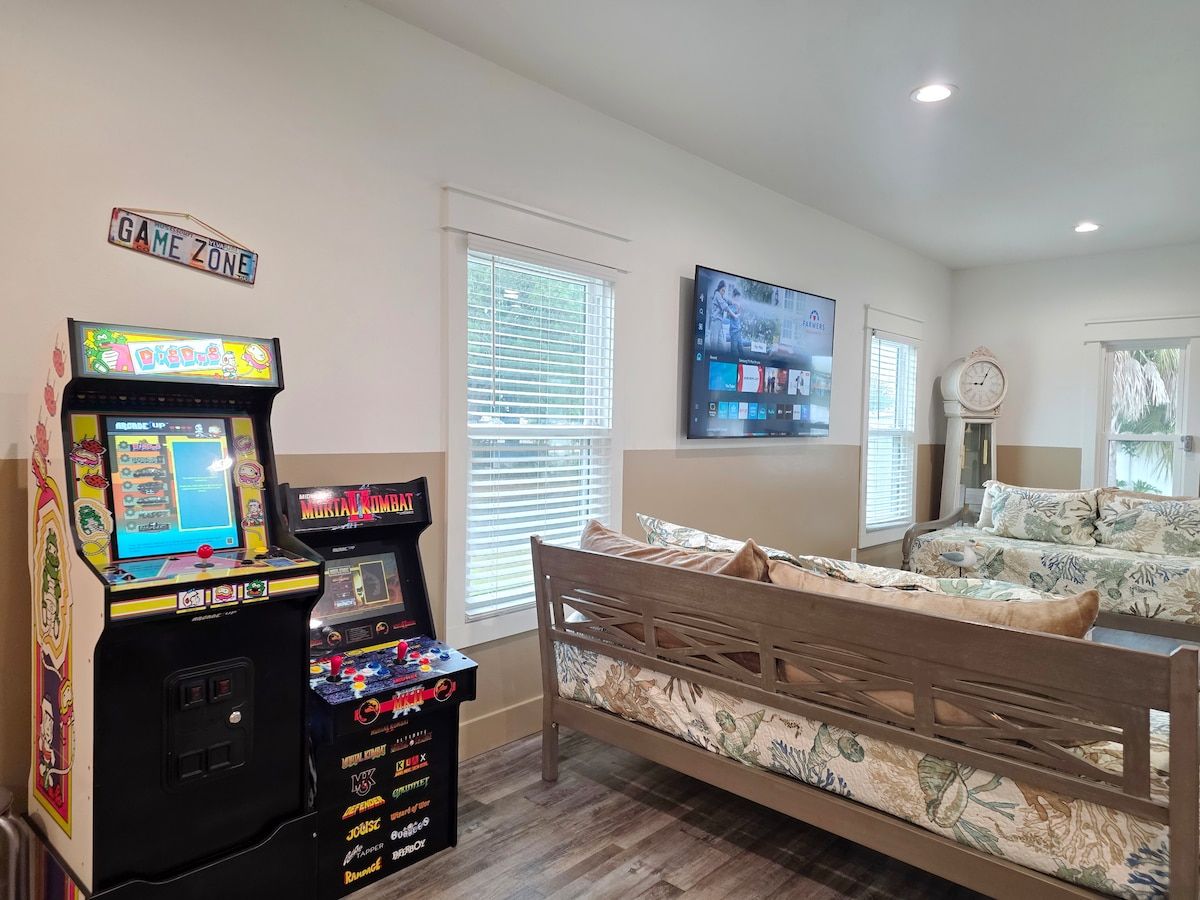 Living Room has 2 gaming systems w/ 3 twin size Day Beds, coffee table, with 70" Samsung Smart TV, and large dining table.