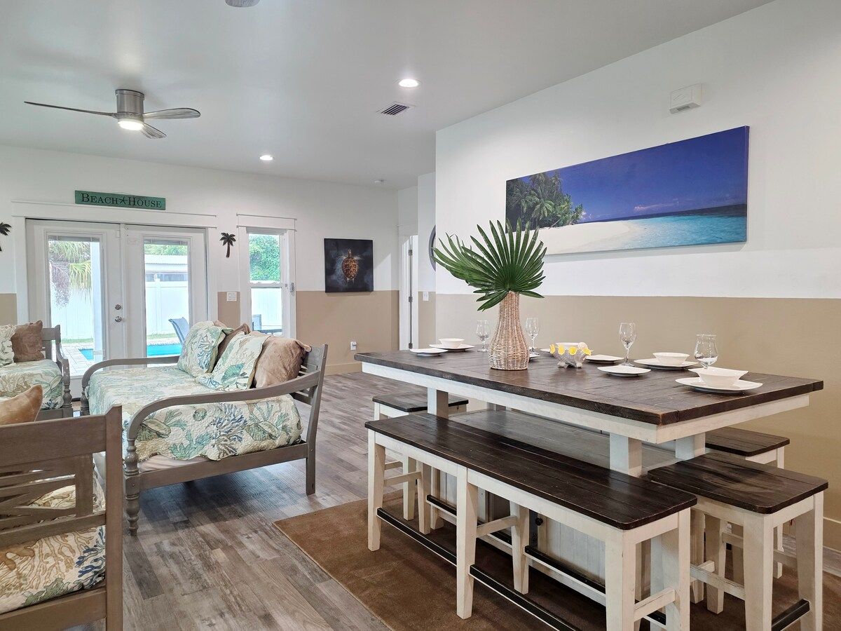 Living Room has 2 gaming systems w/ 3 twin size Day Beds, coffee table, with 70" Samsung Smart TV, and large dining table.
