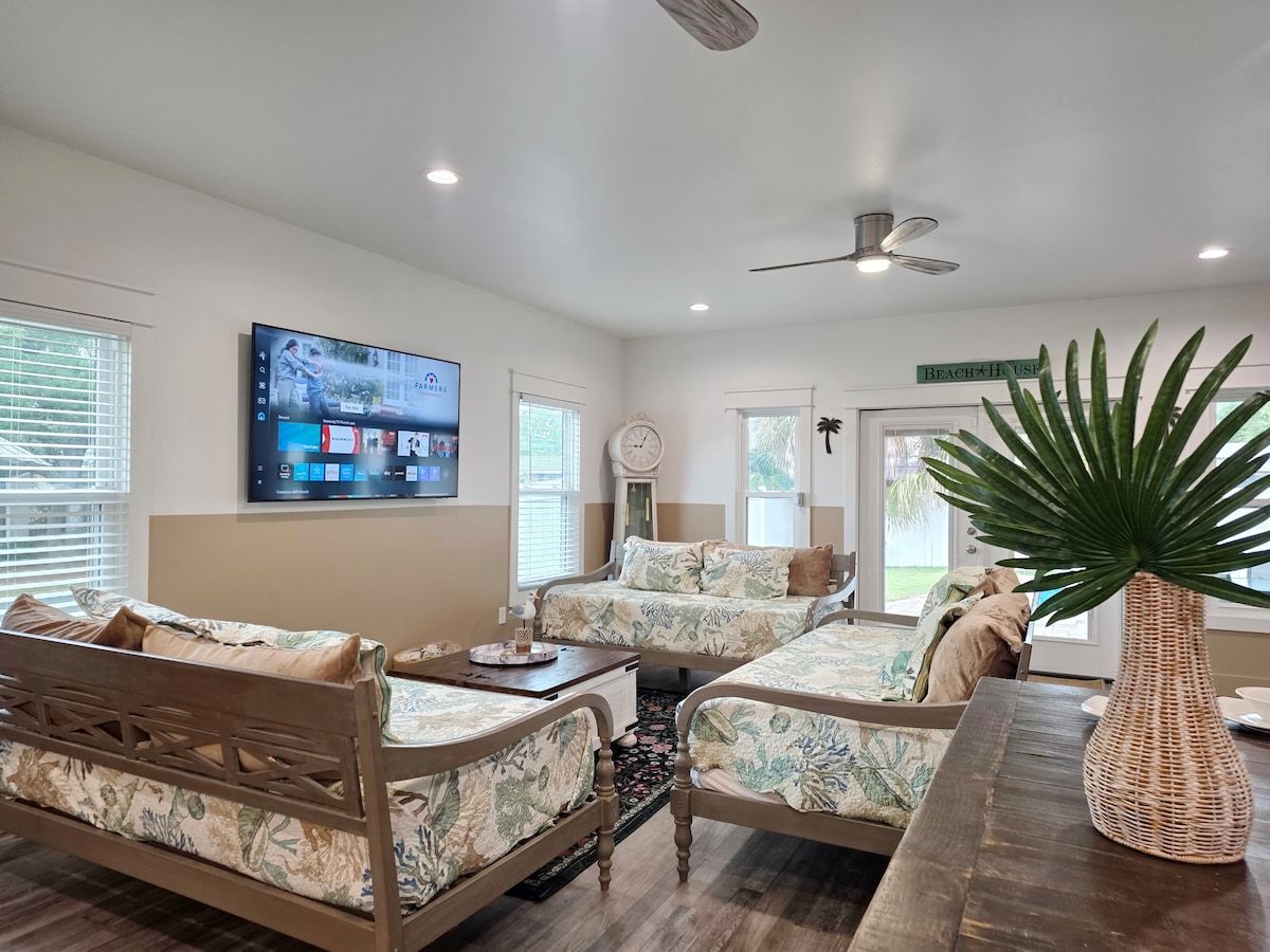 Living Room has 2 gaming systems w/ 3 twin size Day Beds, coffee table, with 70" Samsung Smart TV, and large dining table.
