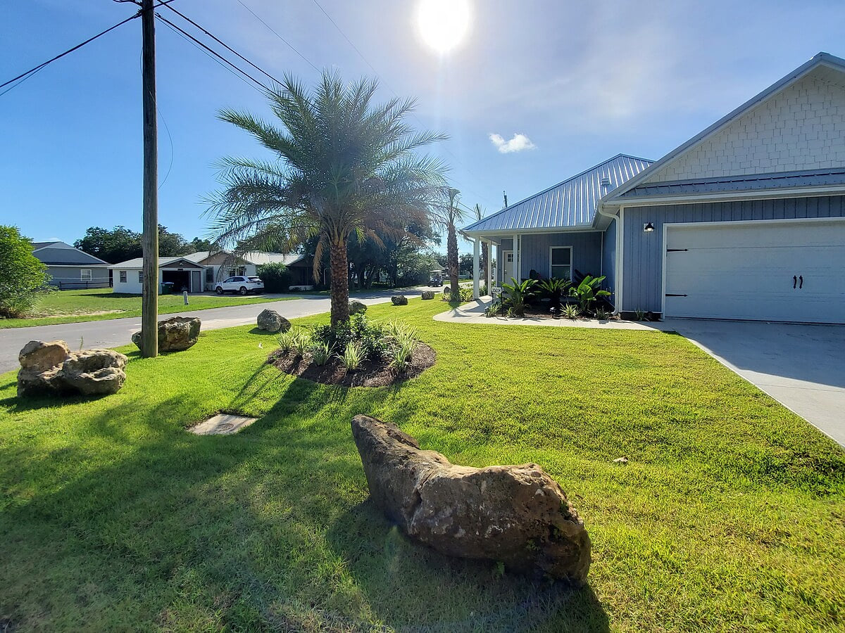 Beautiful Palms, Coral, and Tropical Plants decorate this tropical paradise!  Room for 4 vehicles, 2 in the garage and 2 in the drive way!
