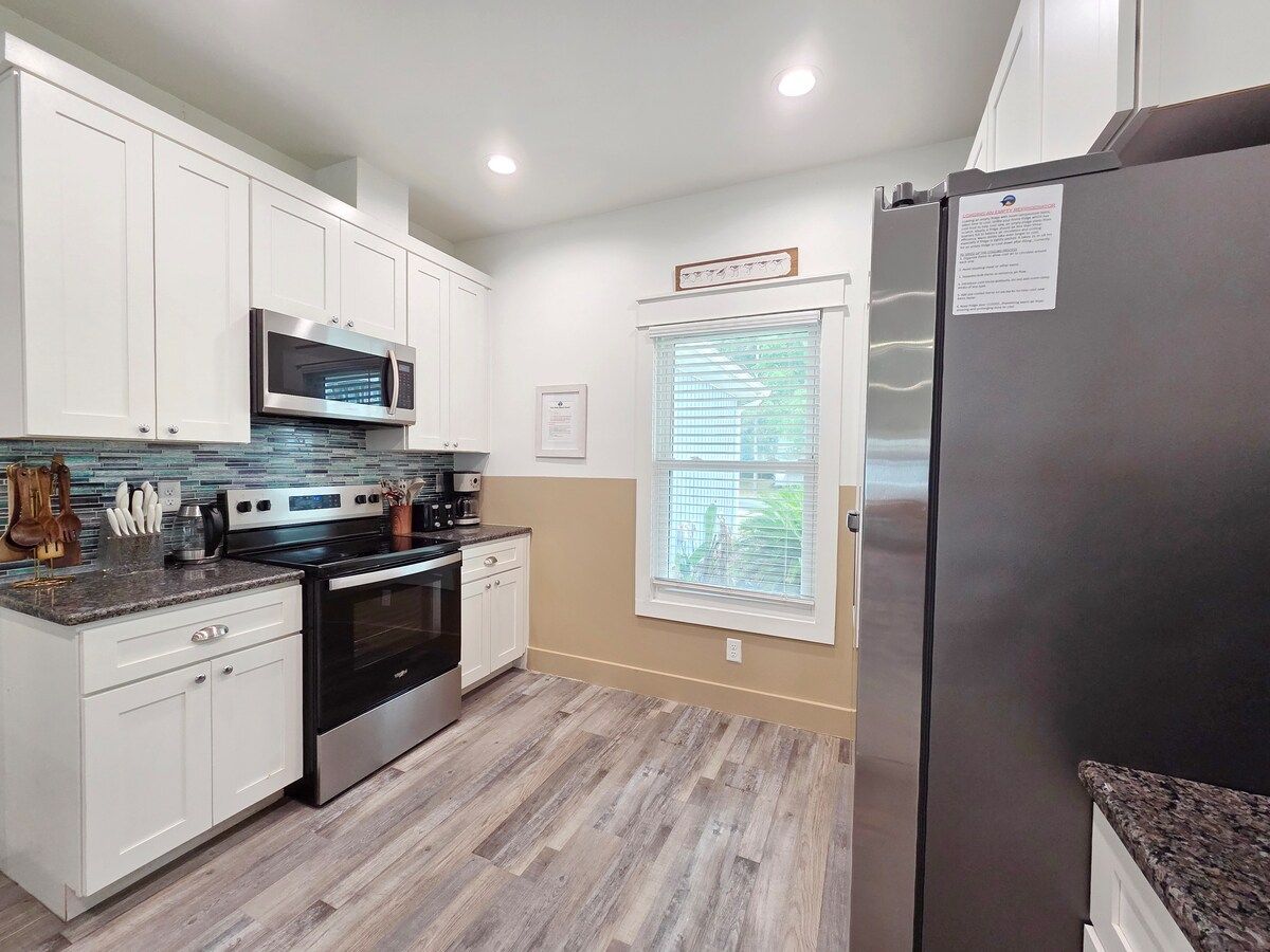 Kitchen w/ all new Stainless Steel appliances including a dishwasher, microwave, coffee maker, blender, and toaster. Room at the bar to sit and enjoy a snack or eat any meal.