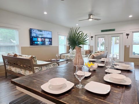 Living Room has 2 gaming systems w/ 3 twin size Day Beds, coffee table, with 70" Samsung Smart TV, and large dining table.