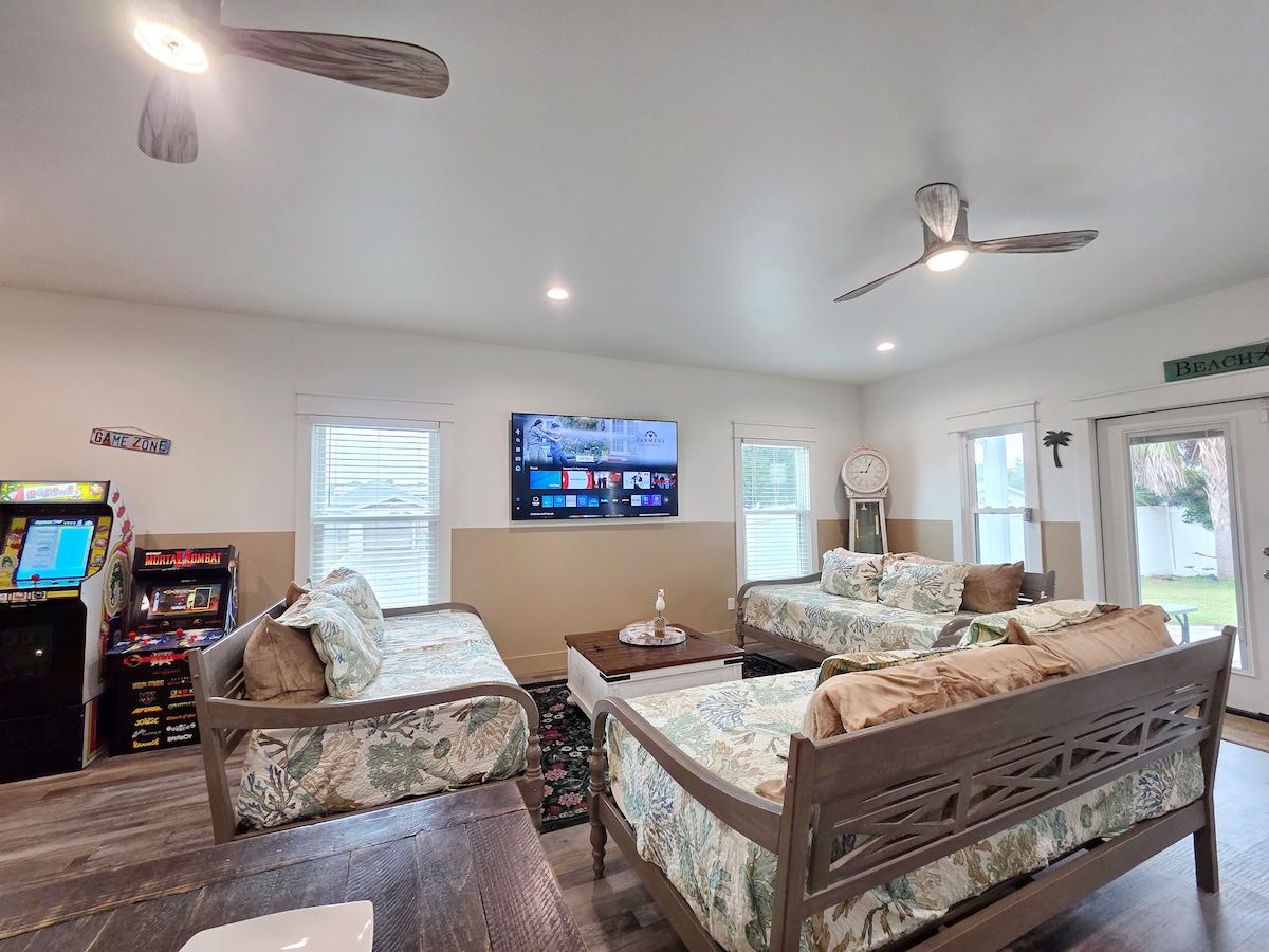 Living Room has 2 gaming systems w/ 3 twin size Day Beds, coffee table, with 70" Samsung Smart TV, and large dining table.