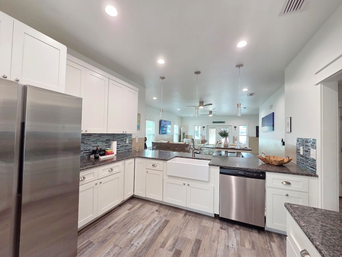 Kitchen w/ all new Stainless Steel appliances including a dishwasher, microwave, coffee maker, blender, and toaster. Room at the bar to sit and enjoy a snack or eat any meal.