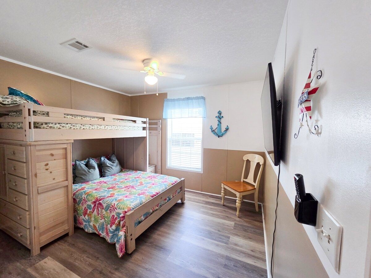 2nd Bedroom with Full size bed and Twin size bed with 55" Samsung Smart TV and power strip for electronic devices.