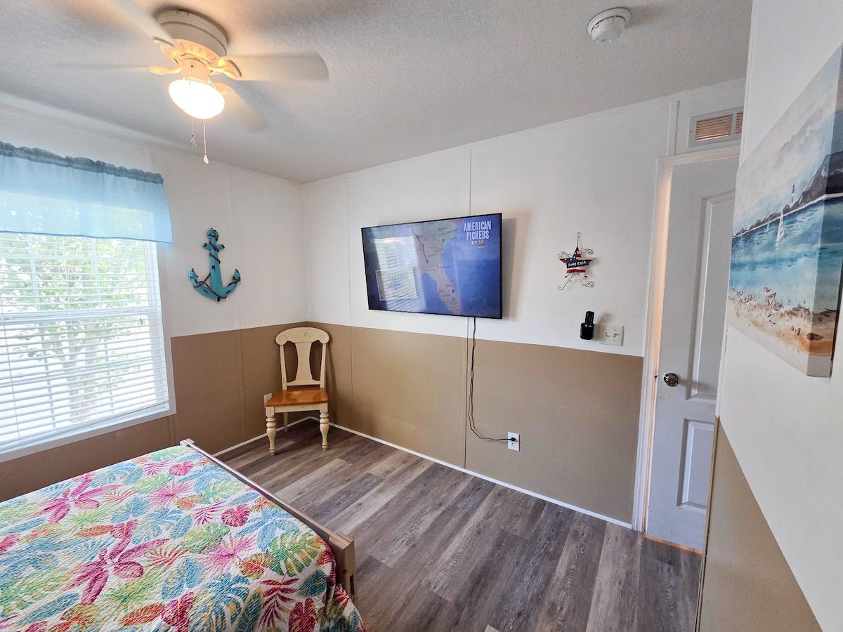 2nd Bedroom with Full size bed and Twin size bed with 55" Samsung Smart TV and power strip for electronic devices.