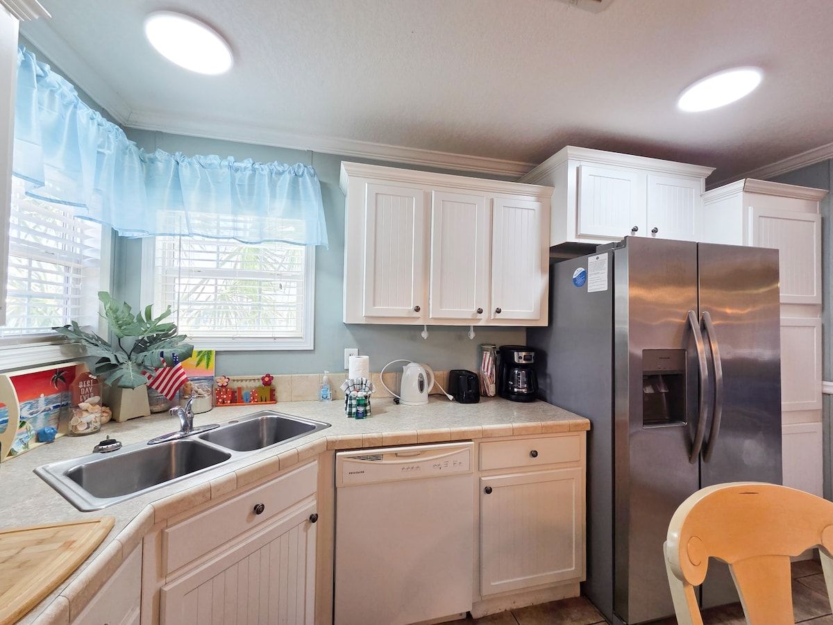 Kitchen with seating for 6 and all necessary items to cook a full meal with Stove, Microwave, Refrigerator, Dishwasher, Coffee Maker, Blender, Toaster, crock pot, etc.