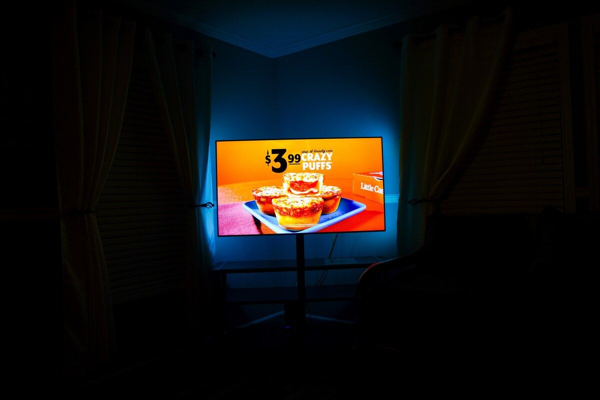 Living Room with 2 twin size Day Beds, Ceiling Fan, power strips for electronic devices, and 55" Samsung Smart TV w/ rear led lighting