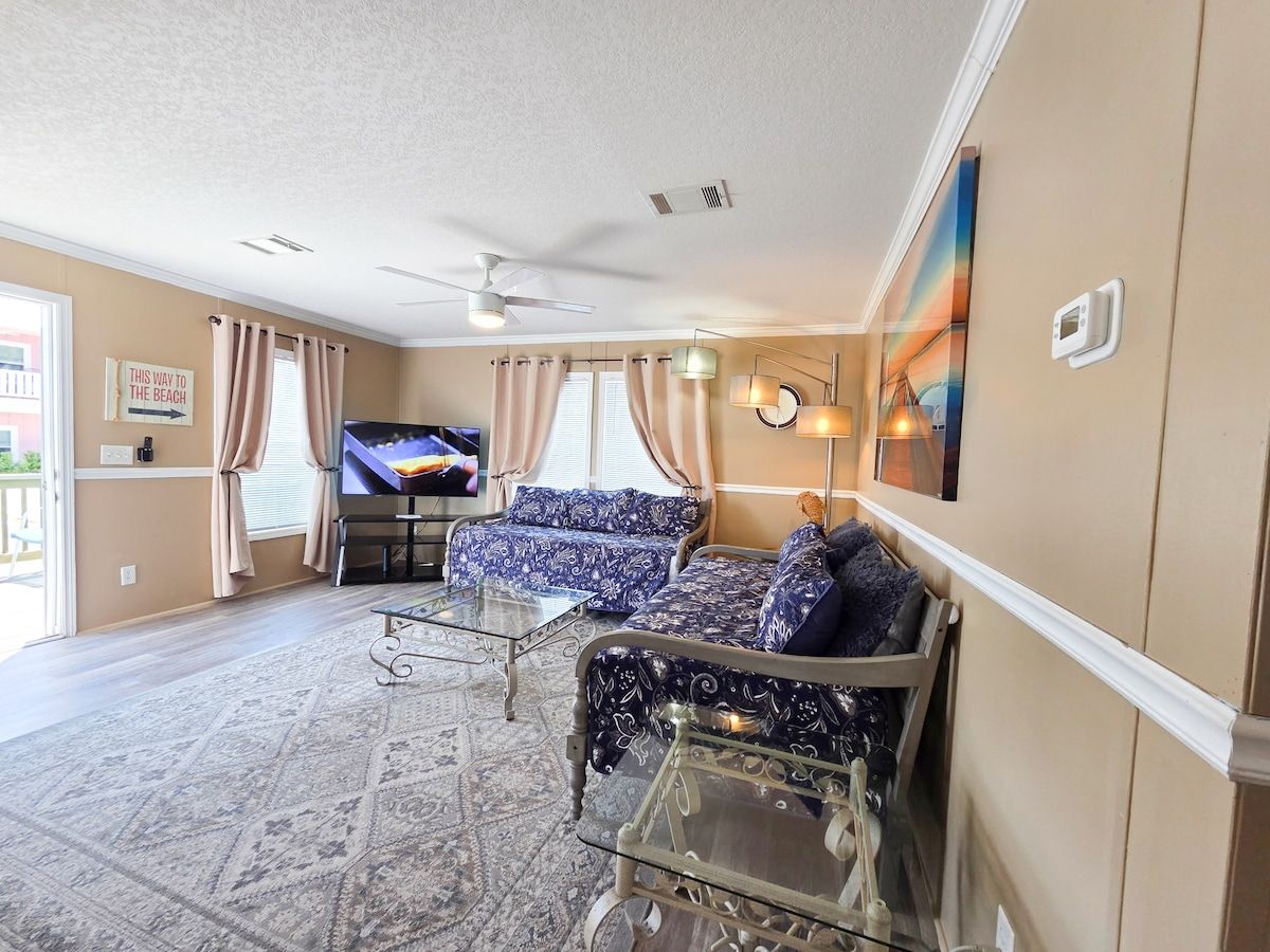 Living Room with 2 twin size Day Beds, Ceiling Fan, power strips for electronic devices, and 55" Samsung Smart TV w/ rear led lighting