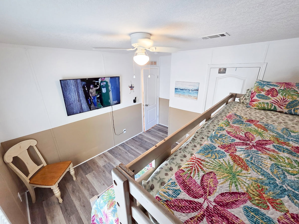 2nd Bedroom with Full size bed and Twin size bed with 55" Samsung Smart TV and power strip for electronic devices.