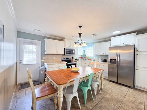 Kitchen with seating for 6 and all necessary items to cook a full meal with Stove, Microwave, Refrigerator, Dishwasher, Coffee Maker, Blender, Toaster, crock pot, etc.
