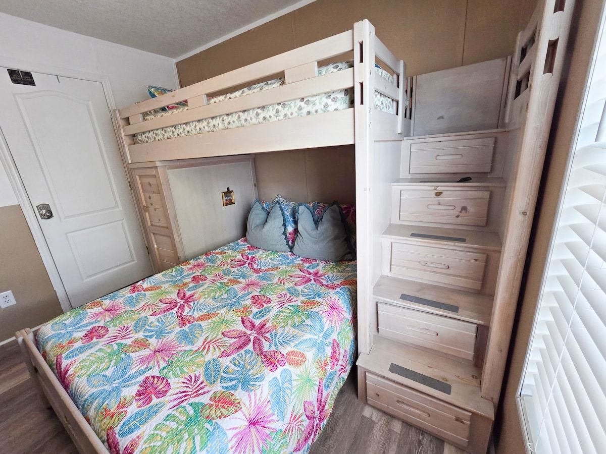 2nd Bedroom with Full size bed and Twin size bed with 55" Samsung Smart TV and power strip for electronic devices.