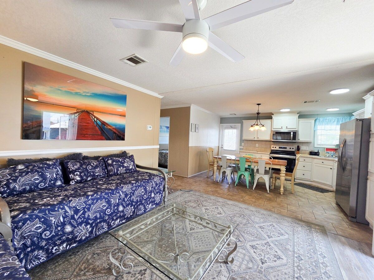 Living Room with 2 twin size Day Beds, Ceiling Fan, power strips for electronic devices, and 55" Samsung Smart TV w/ rear led lighting