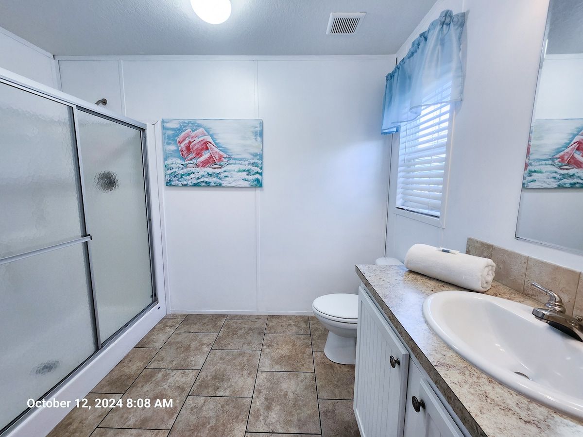 Master Bath with Walk in Shower, toilet, sink, bath towels wash cloths, & hand towels