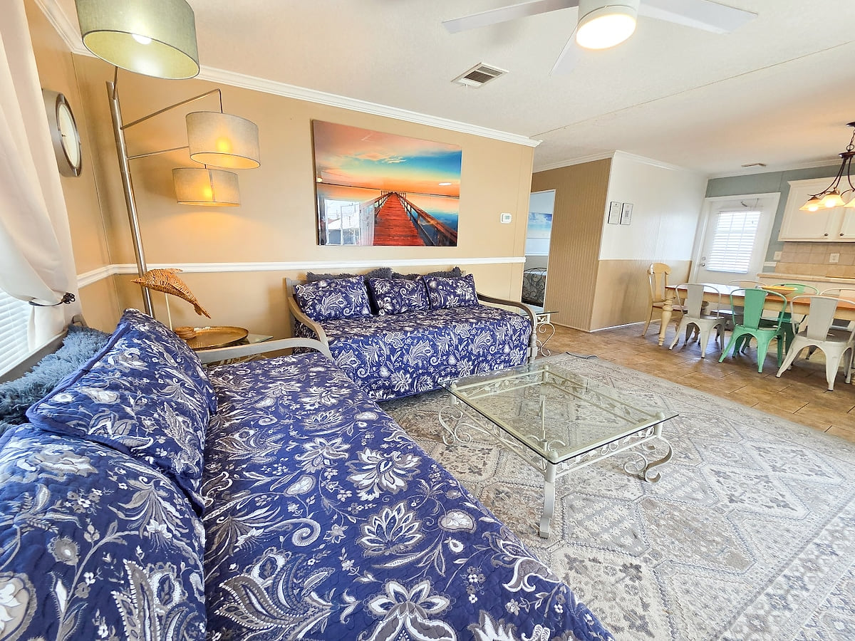 Living Room with 2 twin size Day Beds, Ceiling Fan, power strips for electronic devices, and 55" Samsung Smart TV w/ rear led lighting