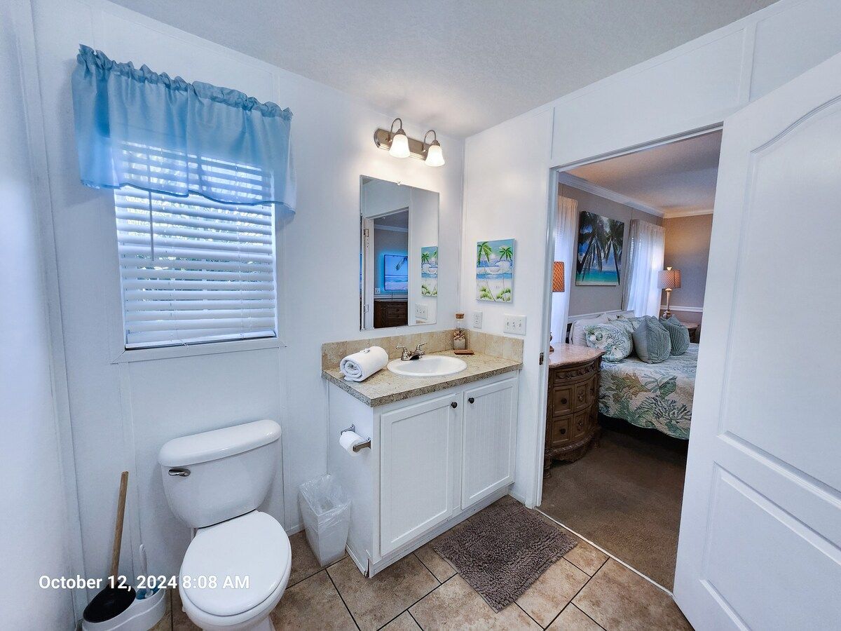 Master Bath with Walk in Shower, toilet, sink, bath towels wash cloths, & hand towels