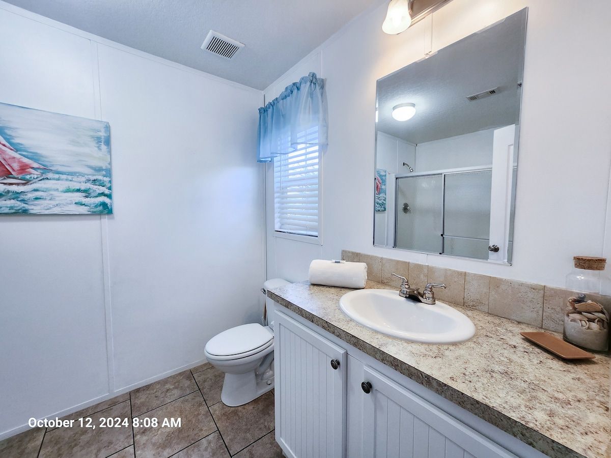 Master Bath with Walk in Shower, toilet, sink, bath towels wash cloths, & hand towels